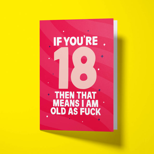 Pink sweary 18th birthday card standing upright and slightly open on a bright yellow background, showing the big ‘18’ and ‘OLD AS FUCK’ lettering.
