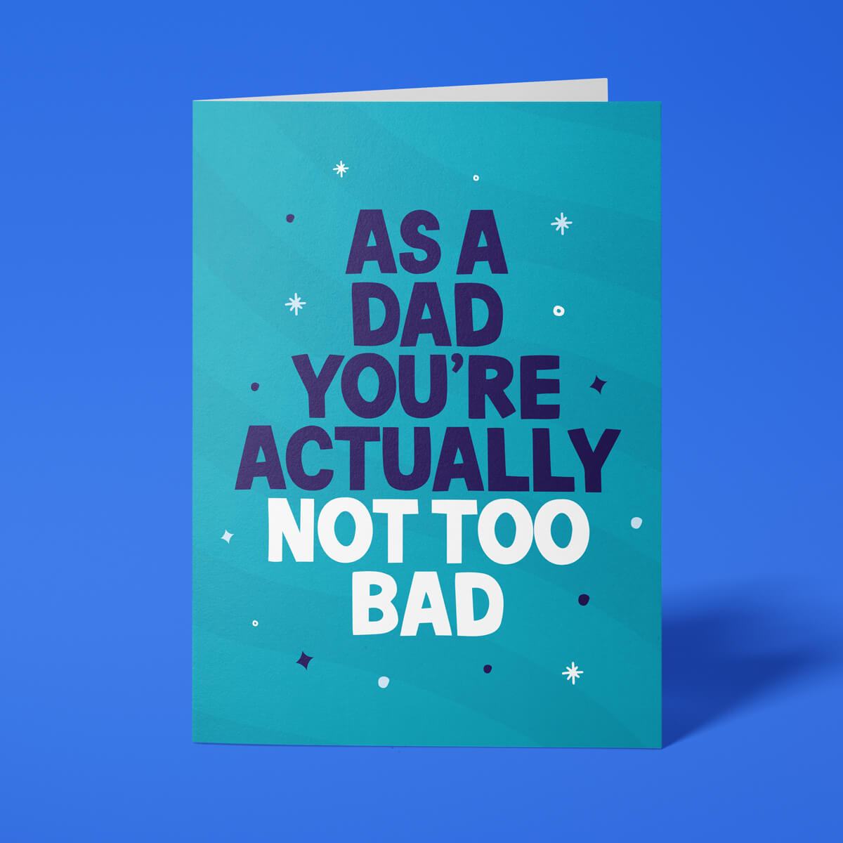 Funny Father's Day card reading 'As A Dad You're Actually Not Too Bad' — teal background, bold block text — Wottahoot