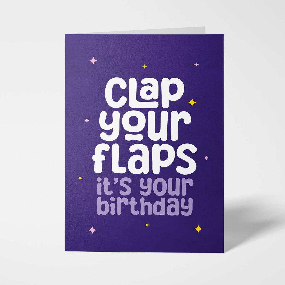 Purple birthday card with white text 'Clap your flaps it's your birthday' on a white background