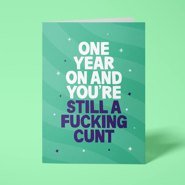 Green rude birthday card featuring 'One year on and you're still a fucking cunt' message in bold lettering