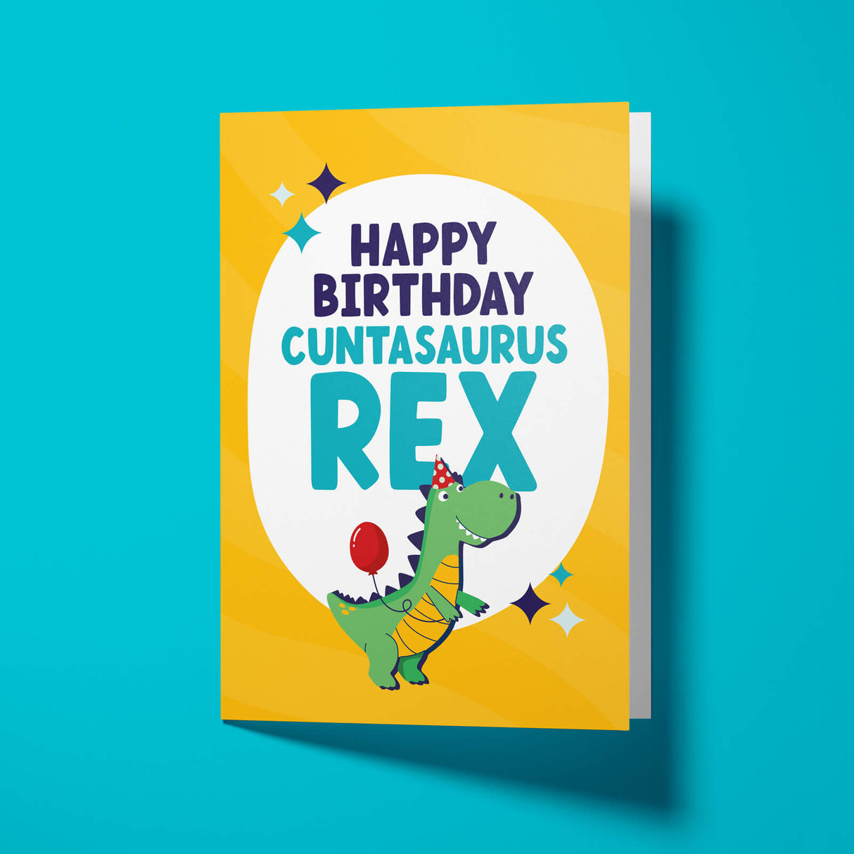 Cunt birthday card reading 'Happy Birthday Cuntasaurus Rex' — yellow background with illustrated party dinosaur, bold navy and teal block text — Wottahoot