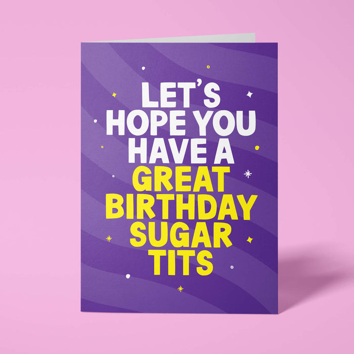 Purple rude birthday card standing upright on a bright background. Bold white and bright yellow chunky typography reads 'LET'S HOPE YOU HAVE A GREAT BIRTHDAY SUGAR TITS' over purple wave stripes with white and yellow sparkle details.