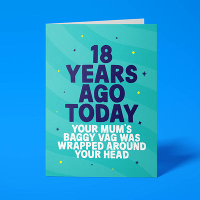 Turquoise rude 18th birthday card standing upright on a bright background. Bold dark navy and white chunky typography reads '18 YEARS AGO TODAY YOUR MUM'S BAGGY VAG WAS WRAPPED AROUND YOUR HEAD' over turquoise wave stripes with navy and yellow sparkle details.