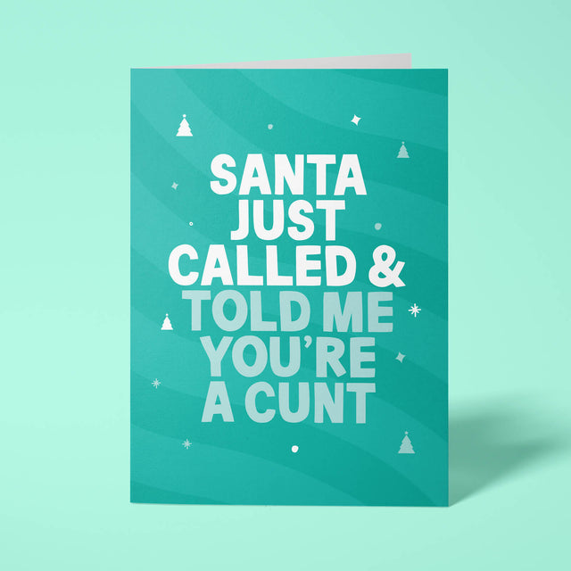 Green rude Christmas card standing upright on a bright background. Bold white and pale mint chunky typography reads 'SANTA JUST CALLED & TOLD ME YOU'RE A CUNT' over green wave stripes with white Christmas tree and sparkle details.