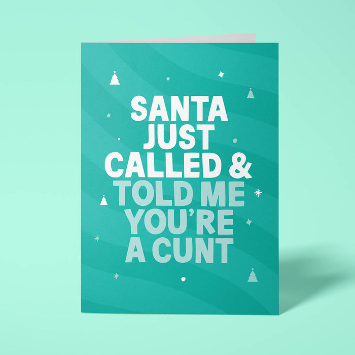 Green rude Christmas card standing upright on a bright background. Bold white and pale mint chunky typography reads 'SANTA JUST CALLED & TOLD ME YOU'RE A CUNT' over green wave stripes with white Christmas tree and sparkle details.