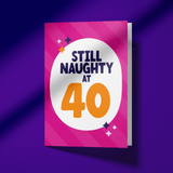Greeting card with 'Still Naughty at 40' text on a pink background