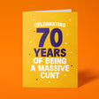 Rude 70th birthday card reading 'Celebrating 70 Years Of Being A Massive Cunt' — yellow background with navy number, bold white block text — Wottahoot