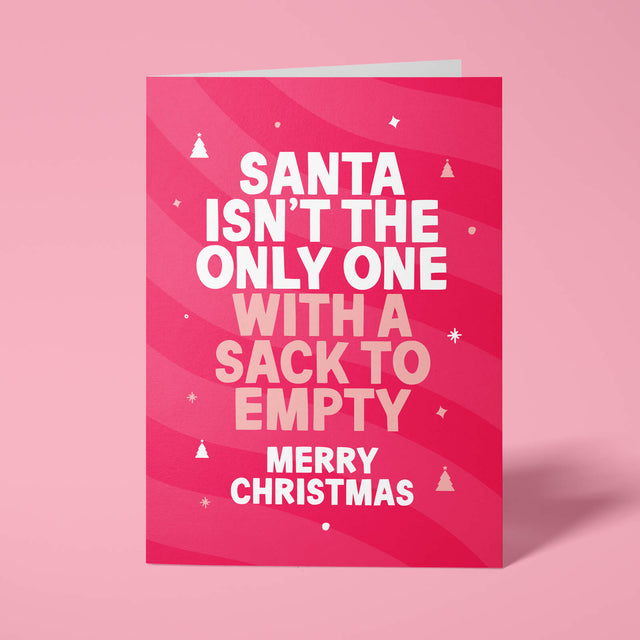 Raspberry pink rude Christmas card standing upright on a bright background. Bold white and pale pink chunky typography reads 'SANTA ISN'T THE ONLY ONE WITH A SACK TO EMPTY MERRY CHRISTMAS' over pink wave stripes with white and pale pink Christmas tree and sparkle details.