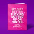 A pink greeting card with bold white text reading 'MY GIFT BETTER FUCKING NOT END UP UP VINTED' and 'HAPPY BIRTHDAY' below, shown standing against a purple background.