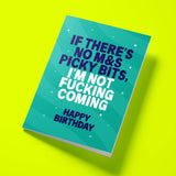 A teal greeting card with bold text reading 'IF THERE'S NO M&S PICKY BITS, I'M NOT FUCKING COMING' and 'HAPPY BIRTHDAY' in white and dark blue, shown at an angle on a bright yellow background.