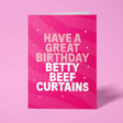 Hot pink rude birthday card standing upright against a pale pink background. Pale pink and white chunky typography reads 'HAVE A GREAT BIRTHDAY BETTY BEEF CURTAINS' over flowing pink wave stripes with white sparkle and dot details.