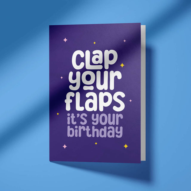 Greeting card with 'Clap your flaps, it's your birthday' text on a purple background