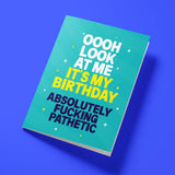 Funny birthday card reading 'Oooh Look At Me It's My Birthday Absolutely Fucking Pathetic' — teal background with yellow accent text, bold block design — Wottahoot