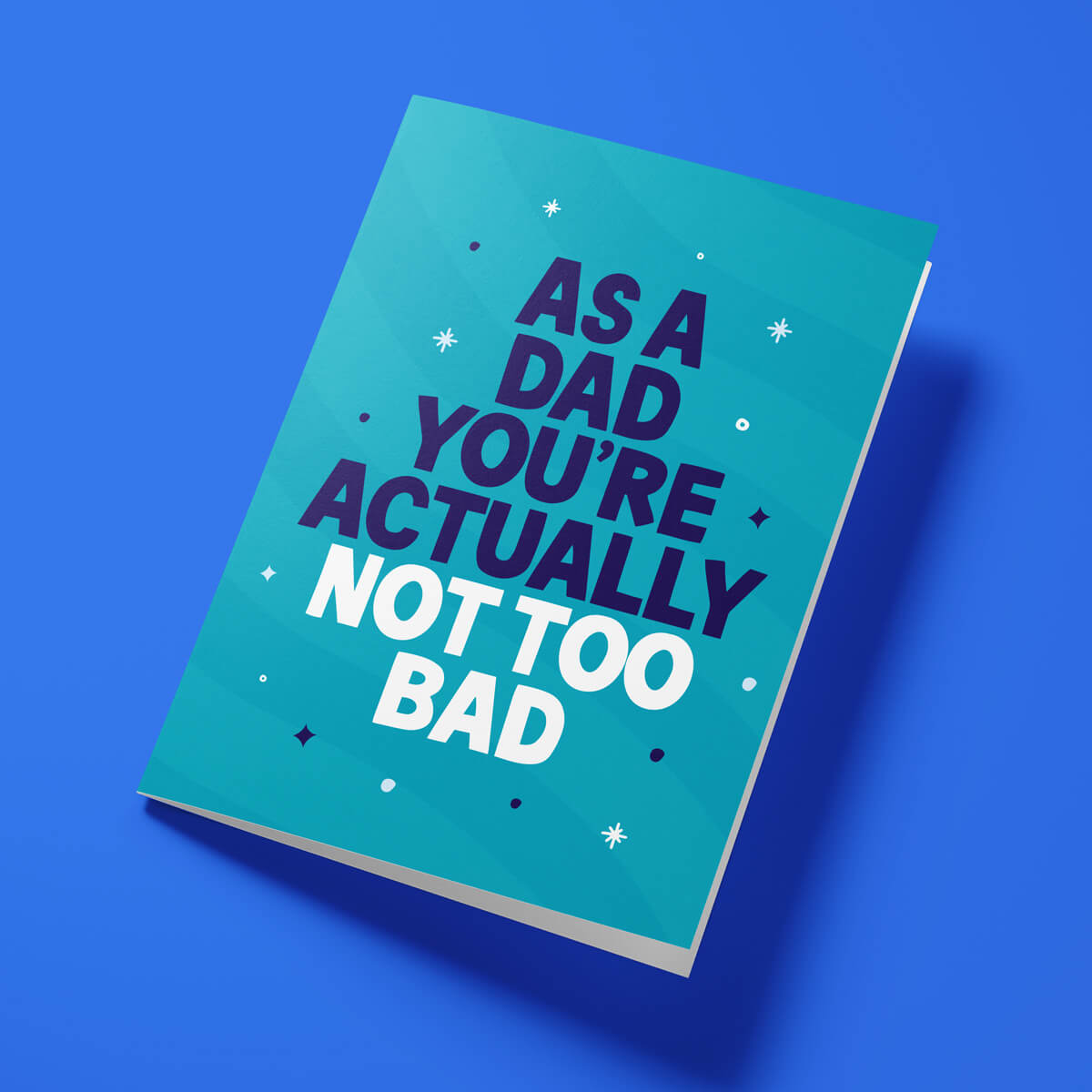 Funny Father's Day card reading 'As A Dad You're Actually Not Too Bad' — teal background, bold block text — Wottahoot