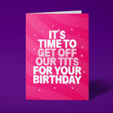 Hot pink A5 greeting card standing upright against a deep purple background. Bold white and pale pink chunky typography reads 'IT'S TIME TO GET OFF OUR TITS FOR YOUR BIRTHDAY'. Diagonal wave and swirl pattern across the card in lighter pink tones with scattered star details.