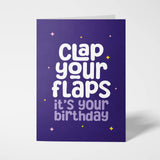 Purple birthday card with white text 'Clap your flaps it's your birthday' on a white background