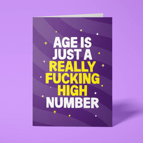 Purple rude birthday card featuring 'Age is just a really fucking high number' message in white and yellow lettering