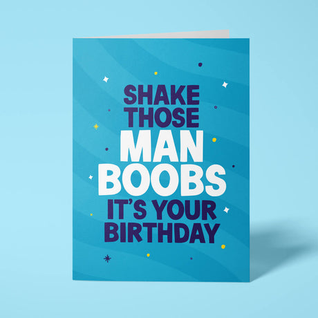 Blue rude birthday card featuring 'Shake those Man Boobs' message in bold white and blue lettering