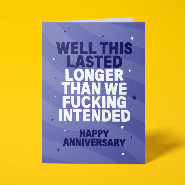 Purple anniversary card with white and lilac block-capital text reading "WELL THIS LASTED LONGER THAN WE FUCKING INTENDED, HAPPY ANNIVERSARY," decorated with hand-drawn stars, dots and sparkle icons.