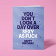 Purple rude birthday card with 'You don't look a day over sexy as fuck' message in bold lettering