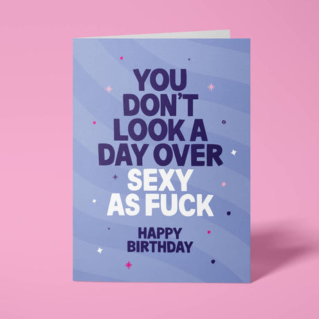 Purple rude birthday card with 'You don't look a day over sexy as fuck' message in bold lettering