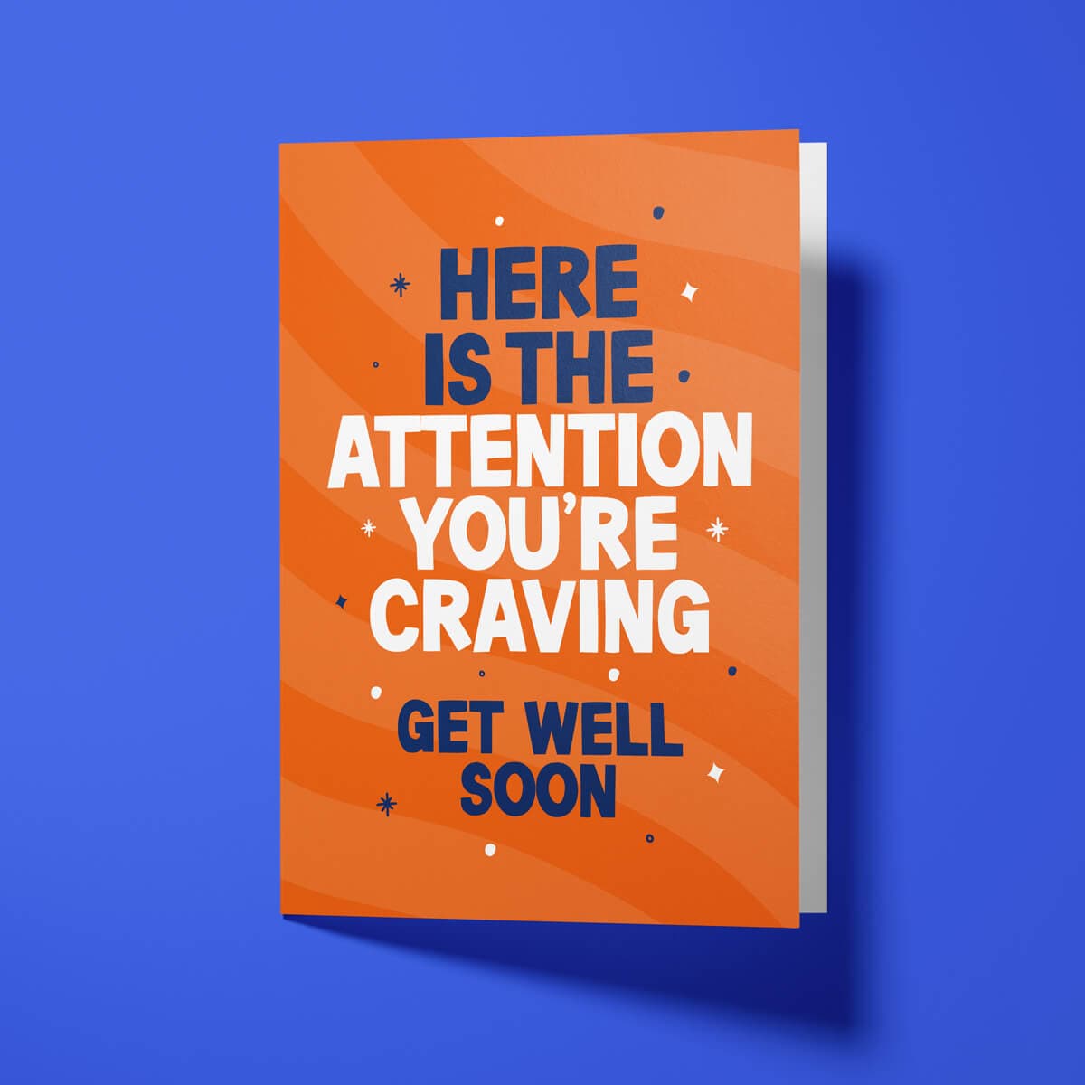 Close-up of the attention-seeking humour text on premium gloss card with orange design