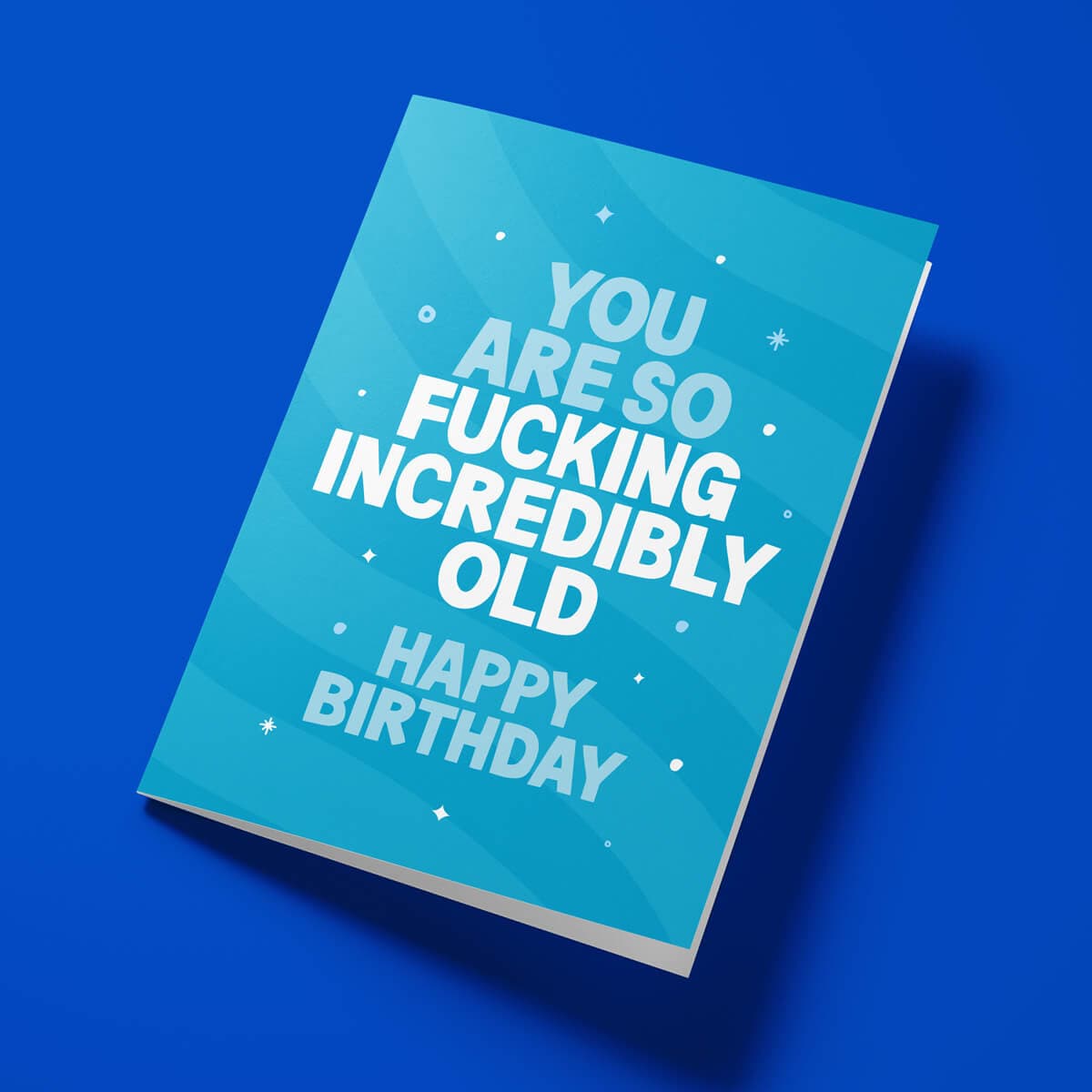 Close-up of the age-related humour text on premium gloss card with vibrant blue design