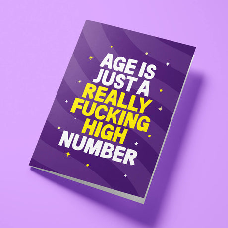 Close-up of the age-related humour text on premium gloss card with vibrant purple design