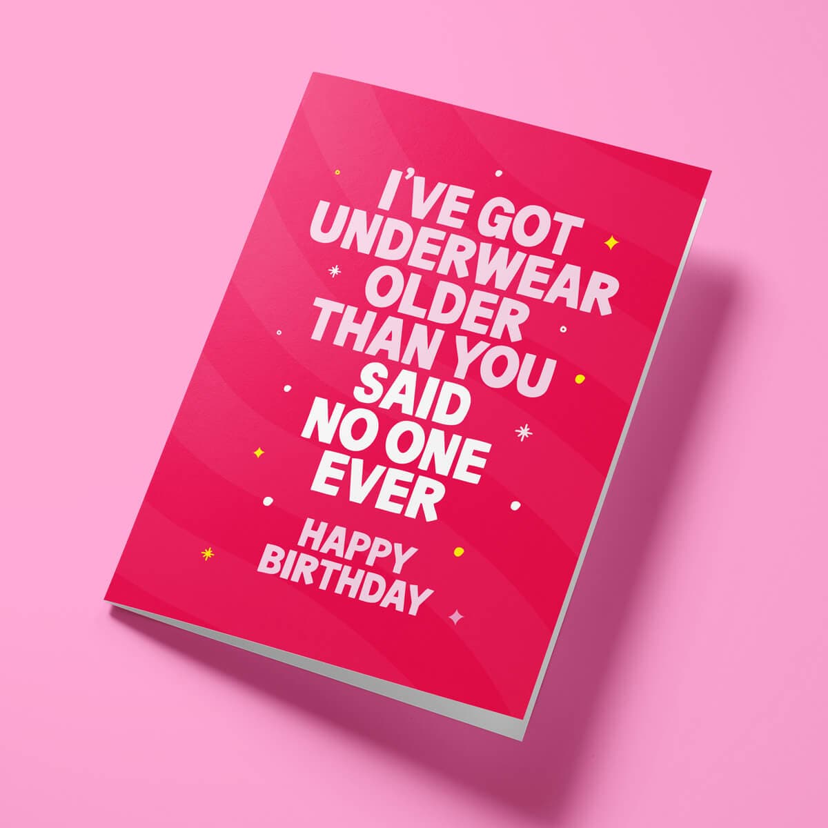 Close-up of rude birthday card showing premium gloss card finish and bright colours